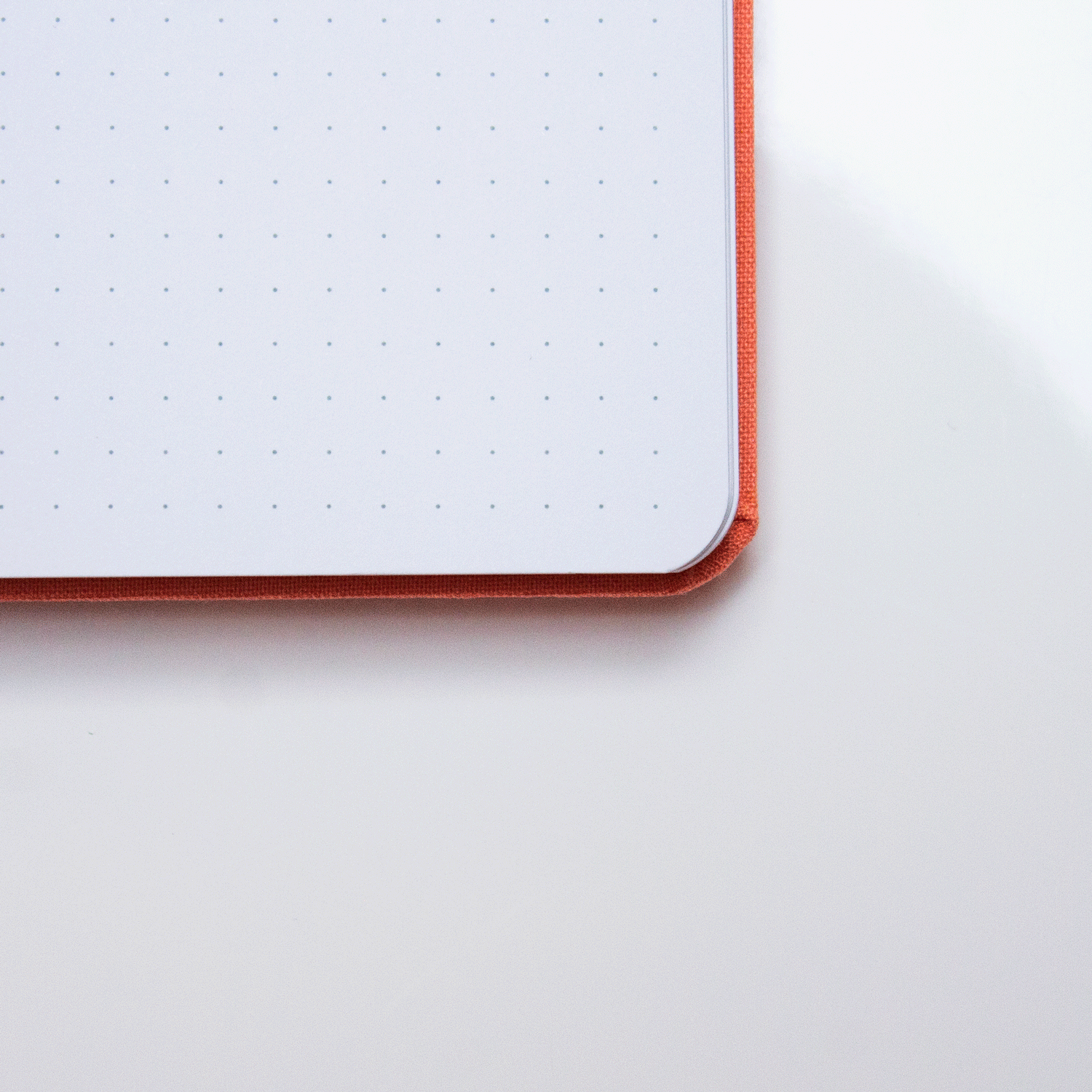 A close up of the Tangerine bobo BuJo dot grid journal opened to show the white dot grid paper.