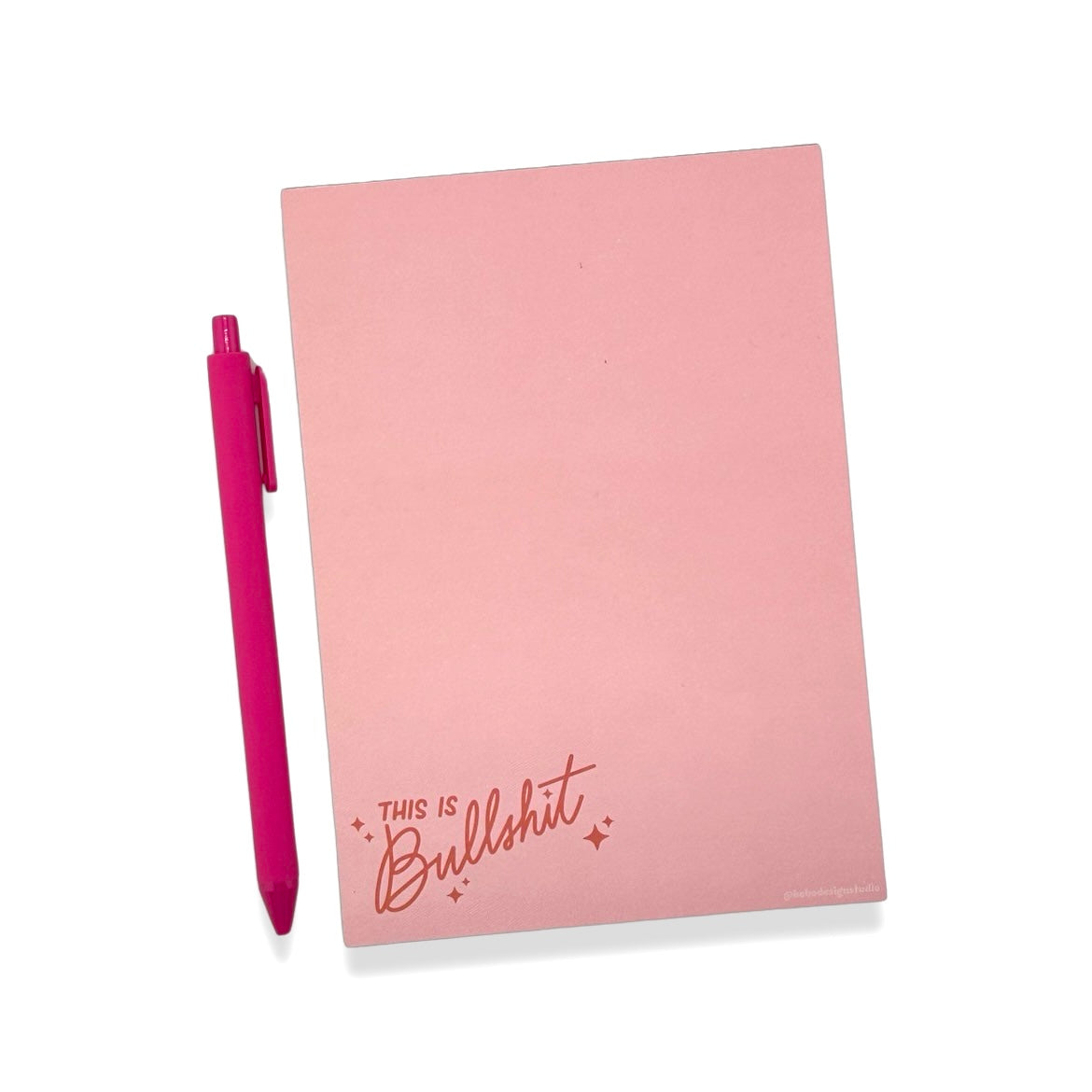 pink this is bullshit notepad with a hot pink pen beside it