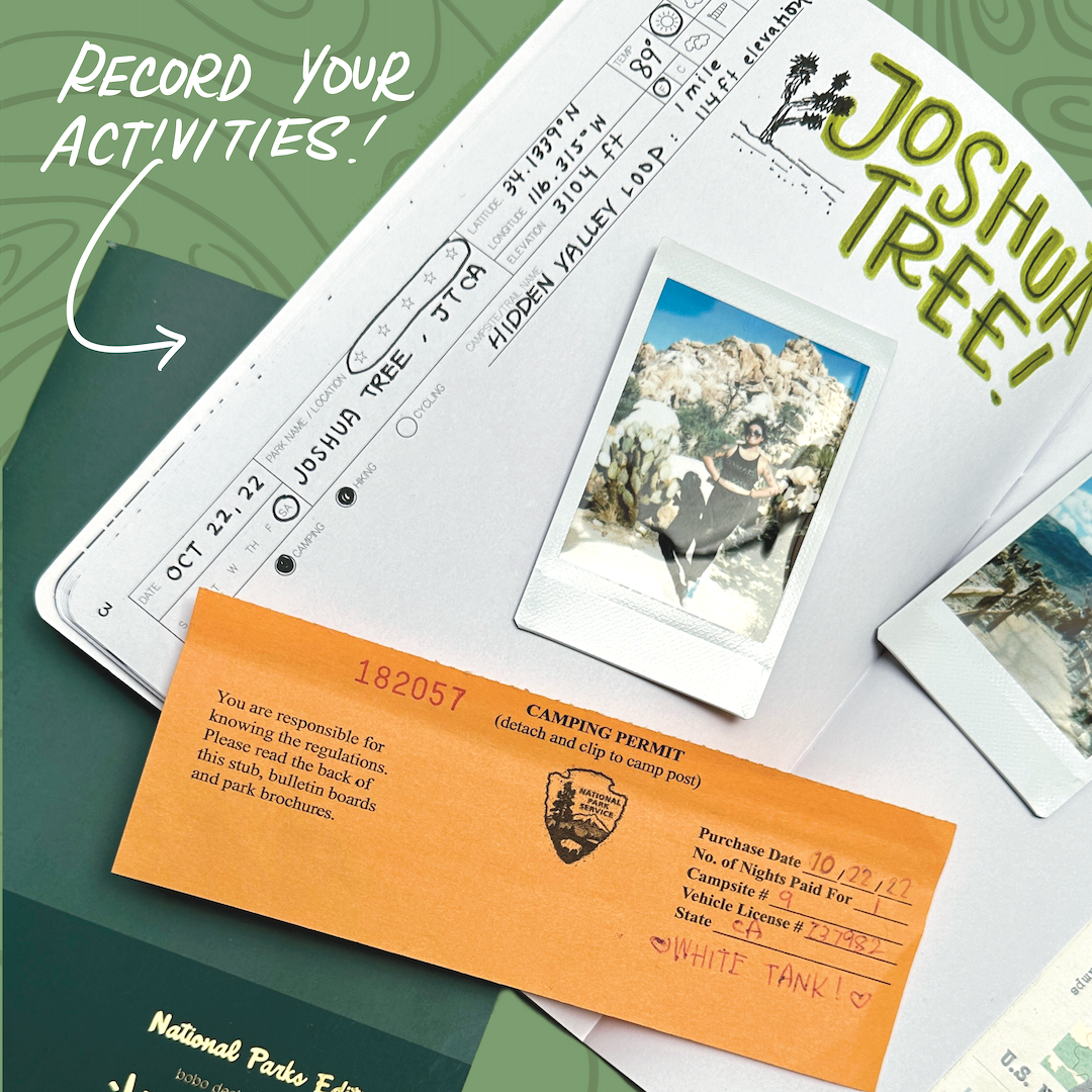 an open national parks wanderlust passport on top of a closed national parks wanderlust passport with white text at the top left saying record your activities with an arrow pointing to a section in the passport. the open passport has joshua tree written on the top of the page with two polaroids laid on top as well as a camping permit laid on top