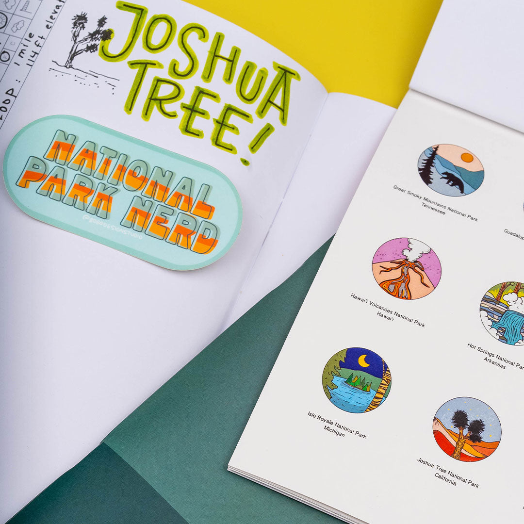 a national parks sticker book on top of a closed national parks wanderlust passport with a national park nerd sticker on top