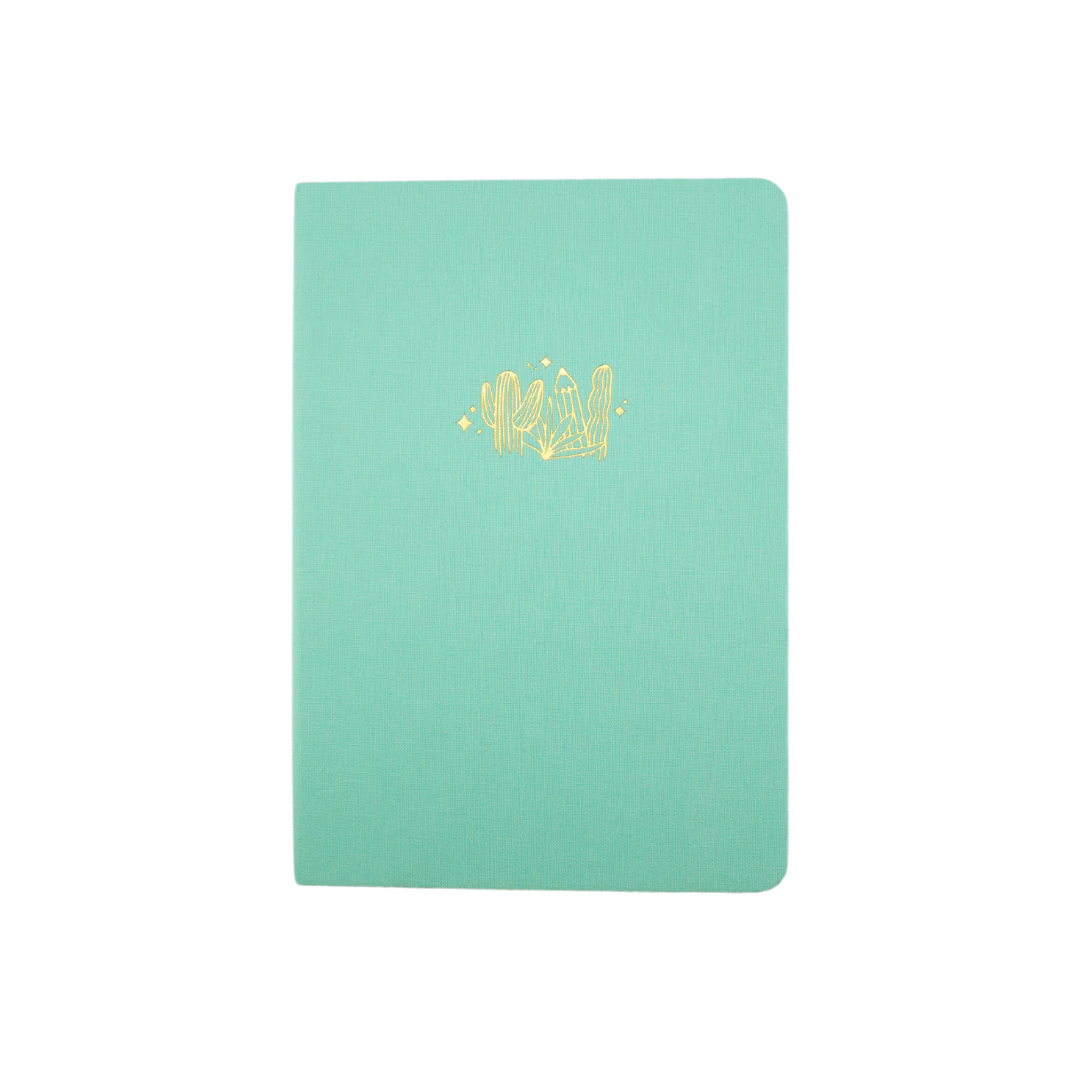 The A5 bobo Lined Journal "Pencil Garden" with a light mint green linen cover. A gold foil illustration of cactus and pencils is stamped onto the front cover.