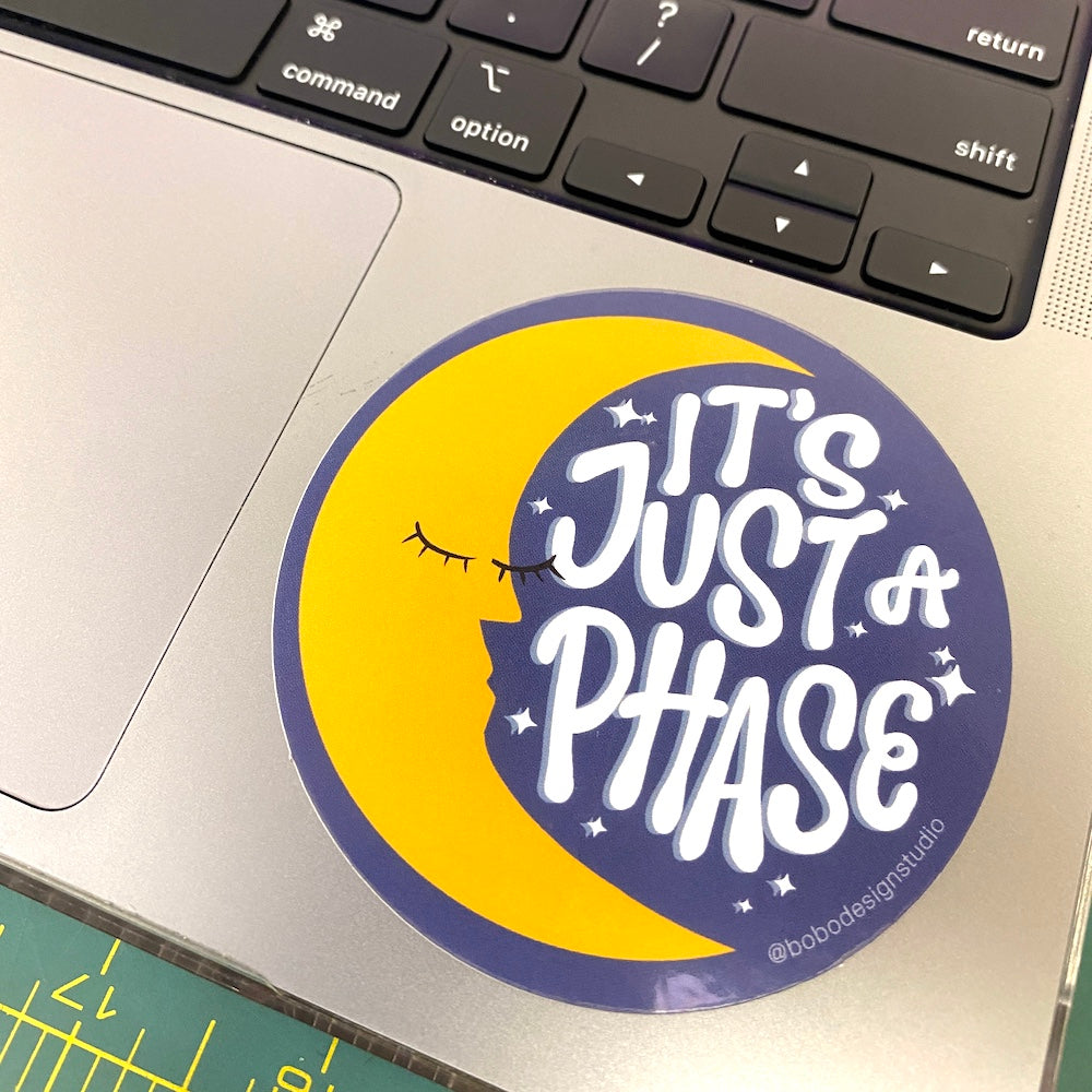its just a phase bobo sticker with a crescent moon with a face on a laptop