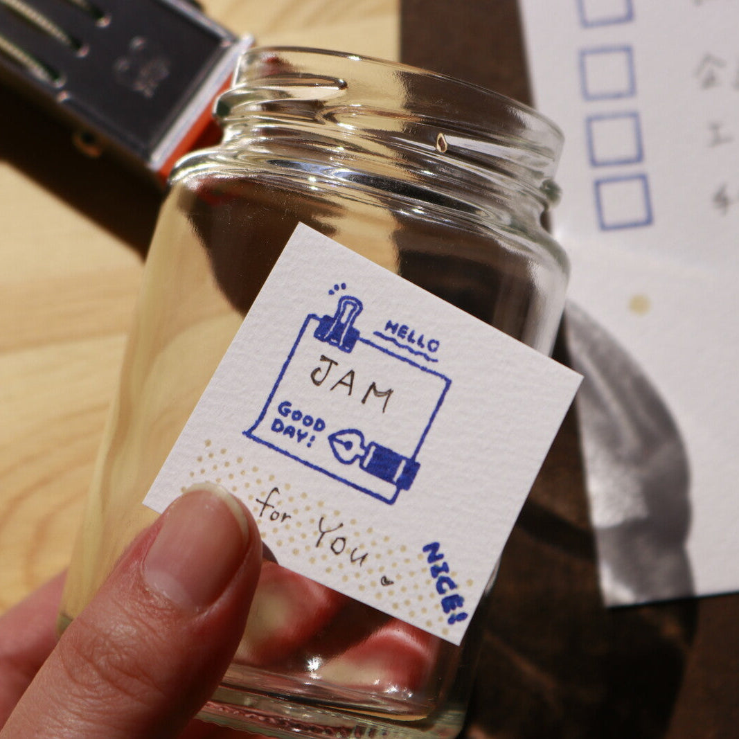 Glass jar with a label on a wooden surface