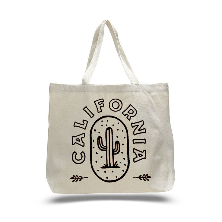 white cream colored tote bag with a black cactus print and the word California in black writing wrapped around the cactus