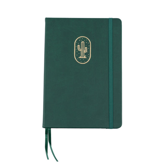 The A5 bobo Black Dot Grid Journal in "Cactus" with a dark green smooth vegan leather cover. A gold foil saguaro cactus illustration is stamped onto the front cover. A matching green  ribbon bookmark and elastic closure can be seen.
