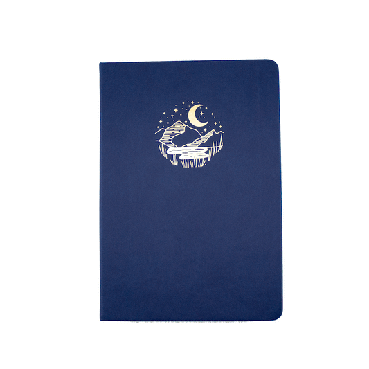 The A5 bobo Black Dot Grid Journal in "Mountain Meadow" with a dark blue vegan leather cover. A gold foil illustration of a mountain marsh under a starry sky and crescent moon is stamped onto the front cover.