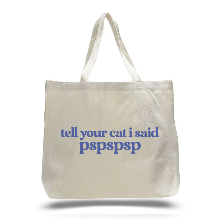 cream white canvas tote bag with " tell your cat i said pspspspsp" in blue lettering 