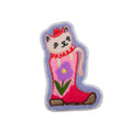 Embroidered patch of a cat in a pink boot with a flower on a white background