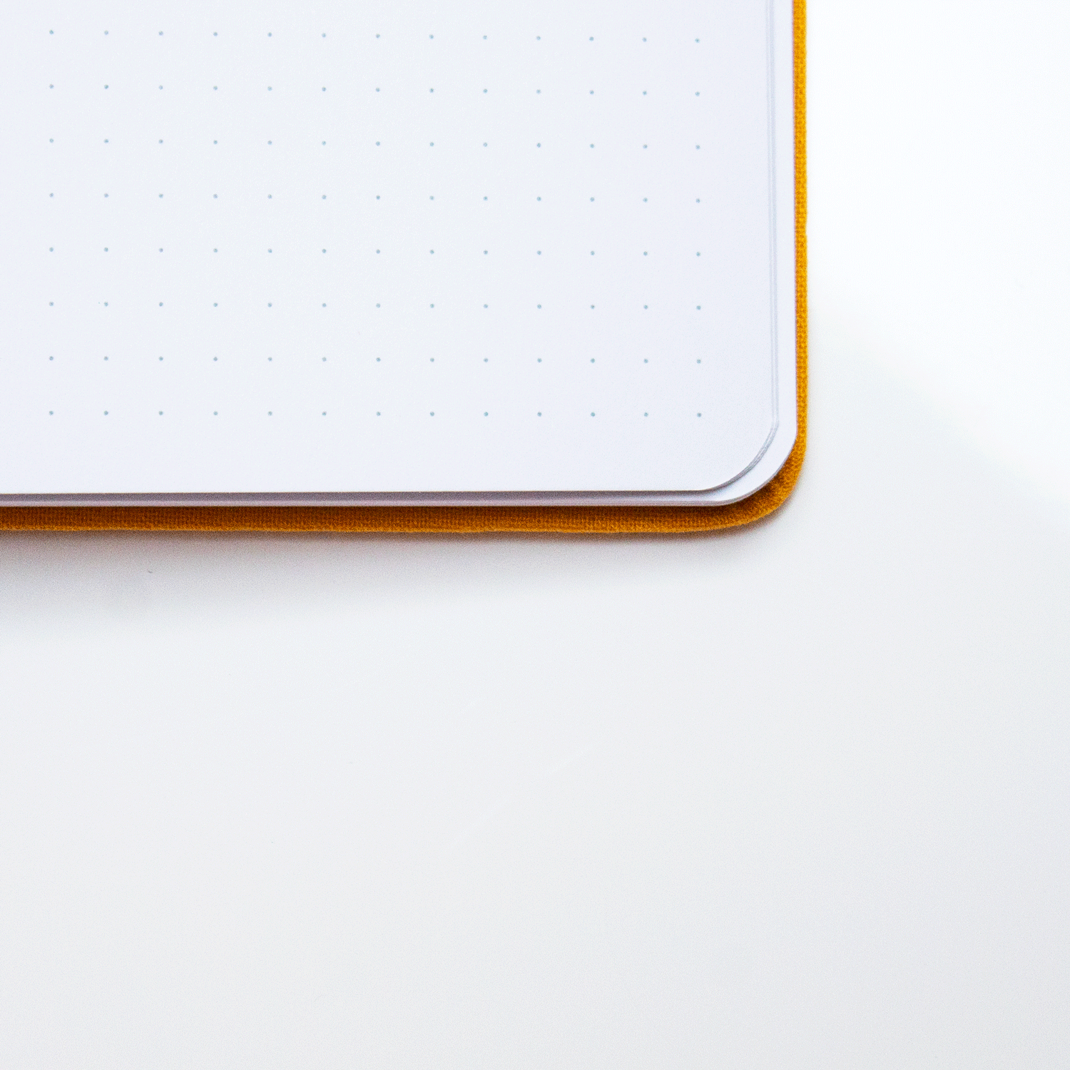 A close up of an opened Golden Dunes bobo BuJo dot grid journal showcasing the white dot grid pages.