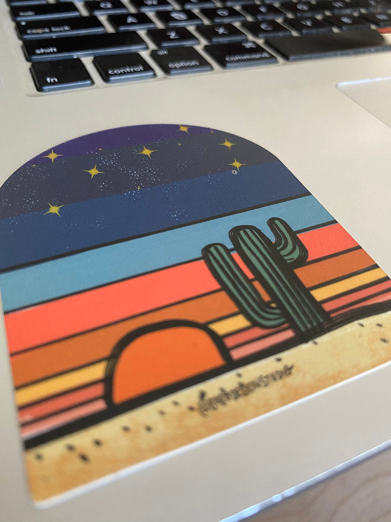 bobo design studio sticker of cactus at sunset titled Desert Globe on a laptop