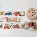 three mod vibes washi tape rolled out one inch wide with abstract lines and shapes on a light beige background
