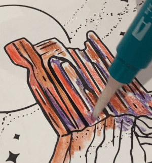A drawing of a desert rock formation being colored in by a moving water brush over  watercolor pencil markings inside the National Parks Coloring Book.