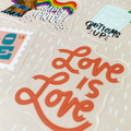 zoomed in image of pride sticker sheet showing a sticker written love is love in red letters