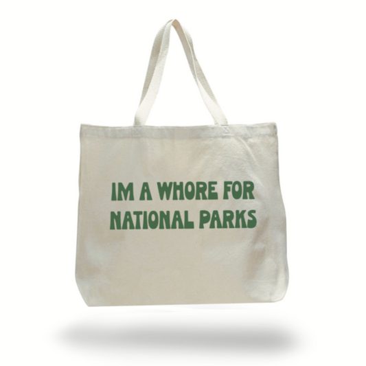 Large natural canvas colored tote bag with "IM A WHORE FOR NATIONAL PARKS" in green.